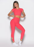 front profile view of a model wearing the Form Flex Leggings in watermelon punch color