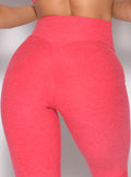 close up back profile view of a model wearing the Form Flex Leggings in watermelon punch color