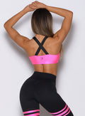 Neon Pink Glow Sports Bra with adjustable cross-back straps and supportive medium-weight fabric.