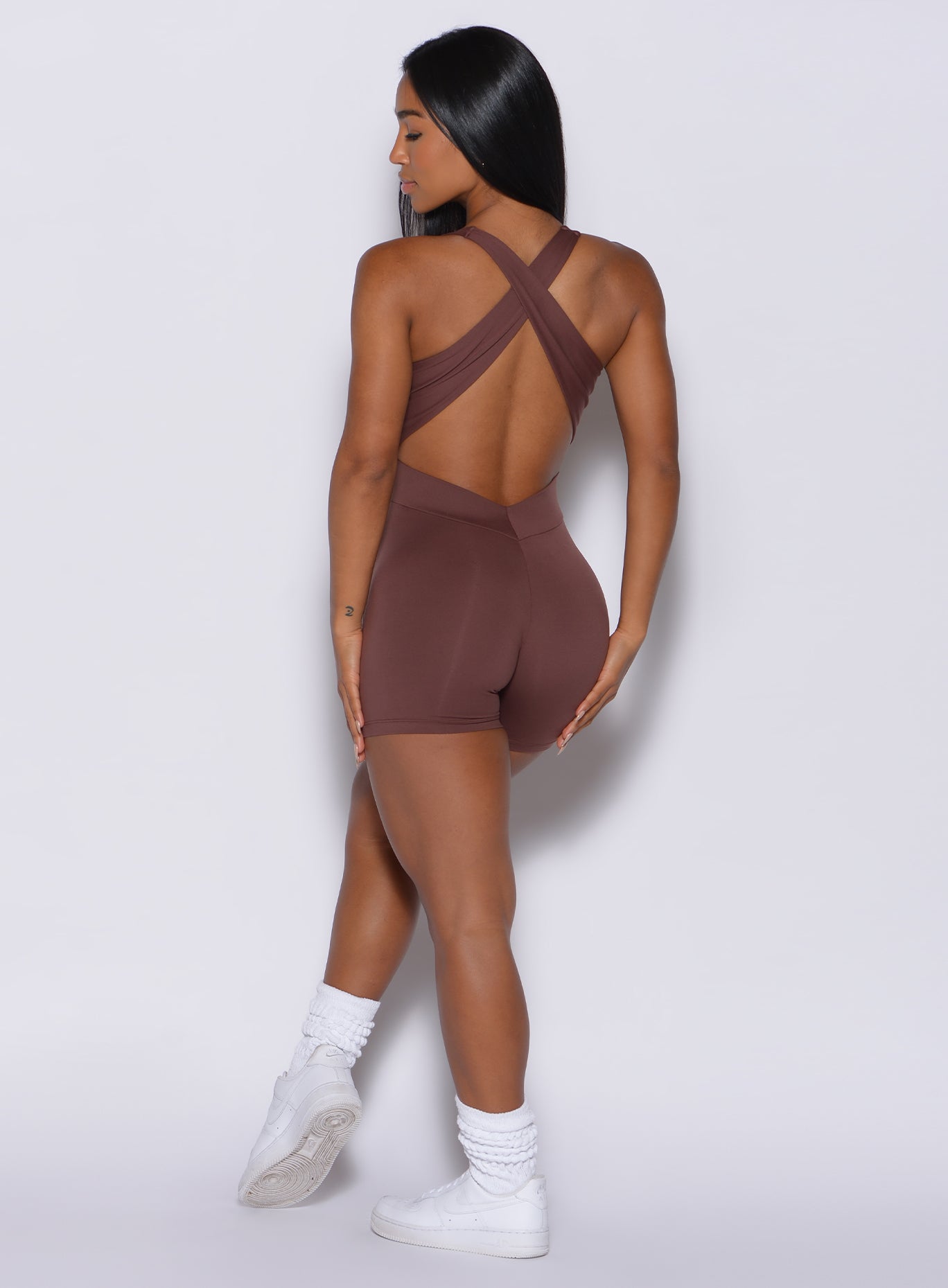 back profile view of a gorgeous model in our laced bodysuit shorts in chocolate color