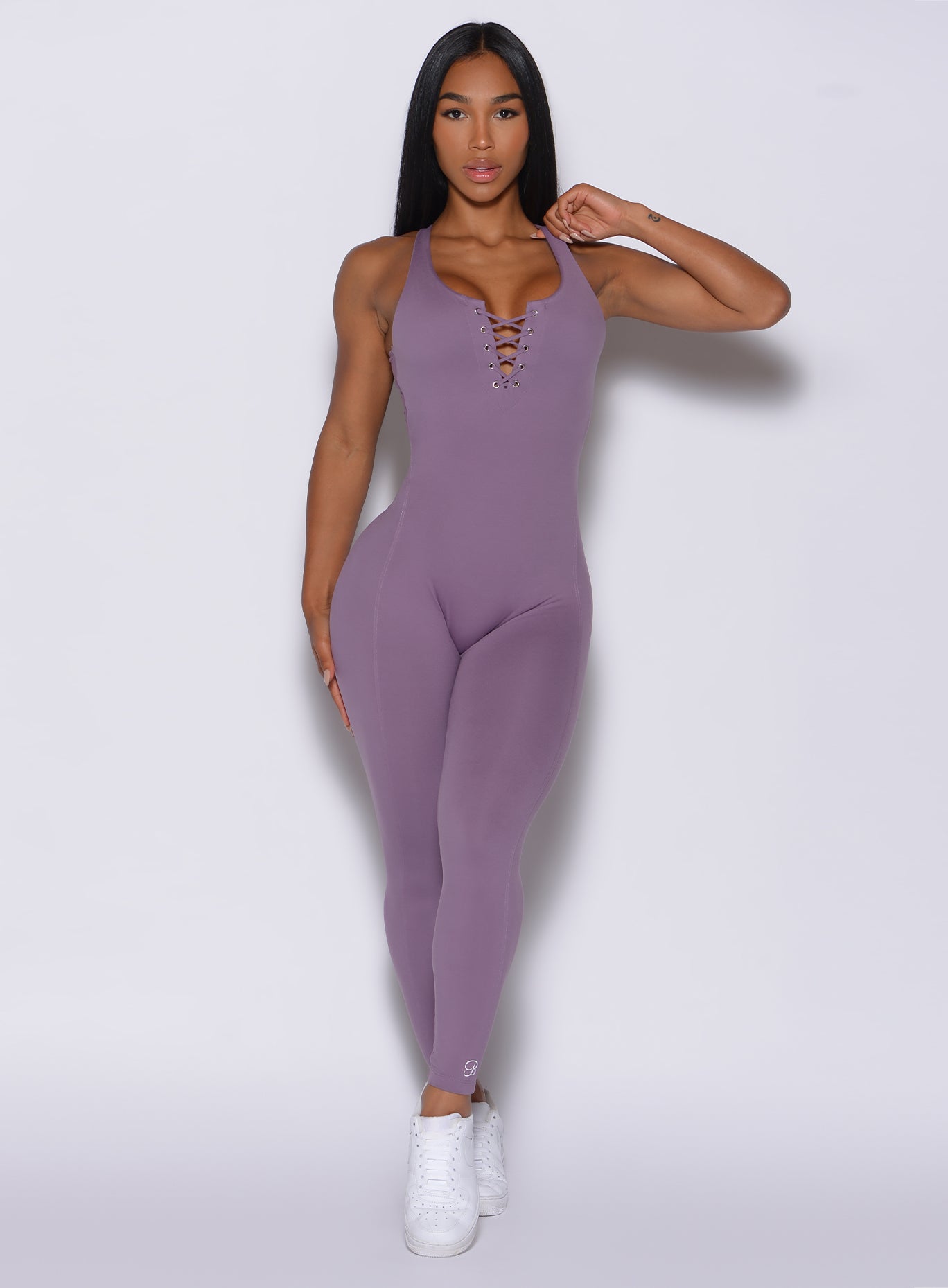 Front profile view of a model in our laced bodysuit in Violet Frost color 