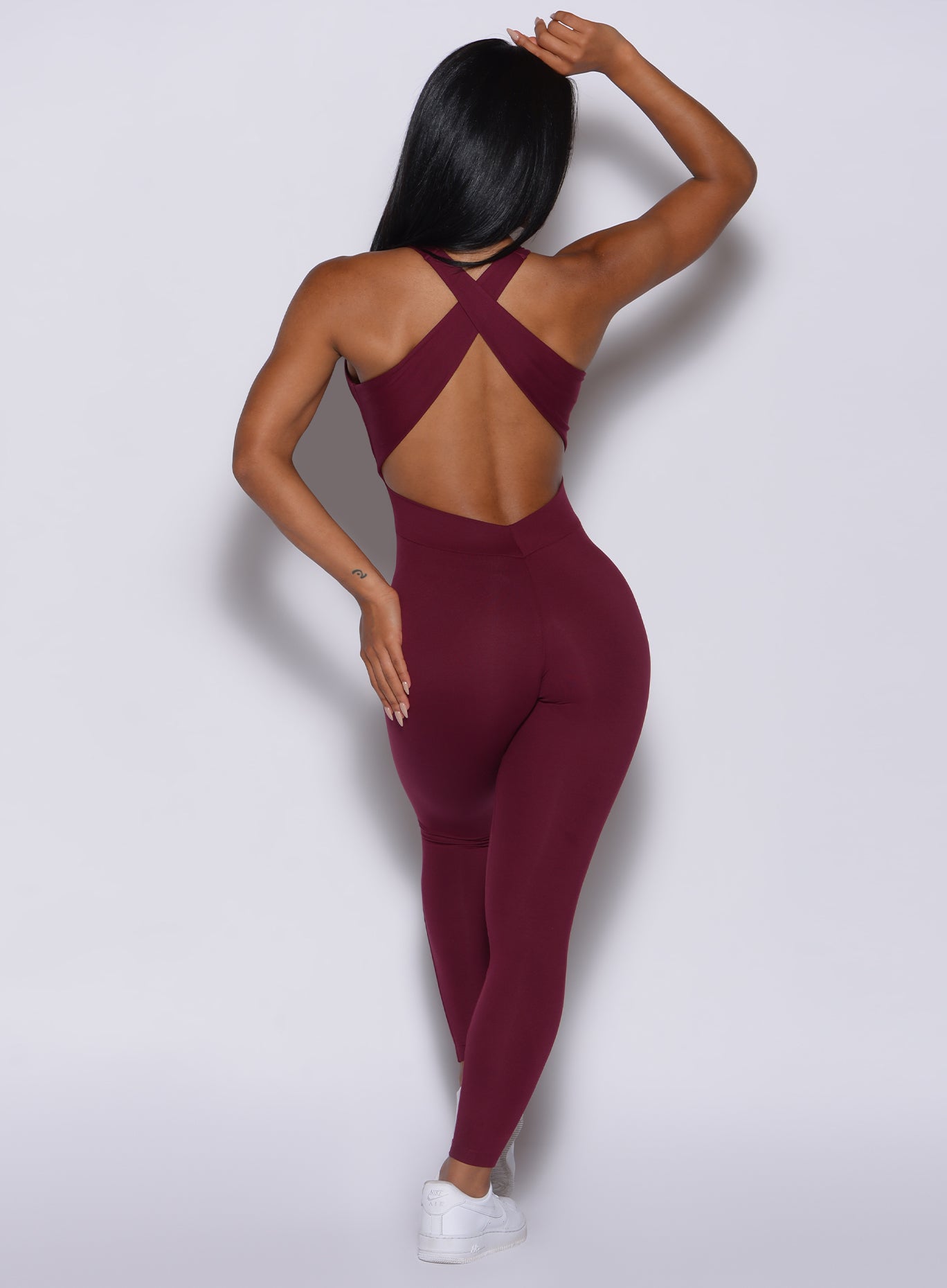 back profile view of a model in our ruby colored laced bodysuit 
