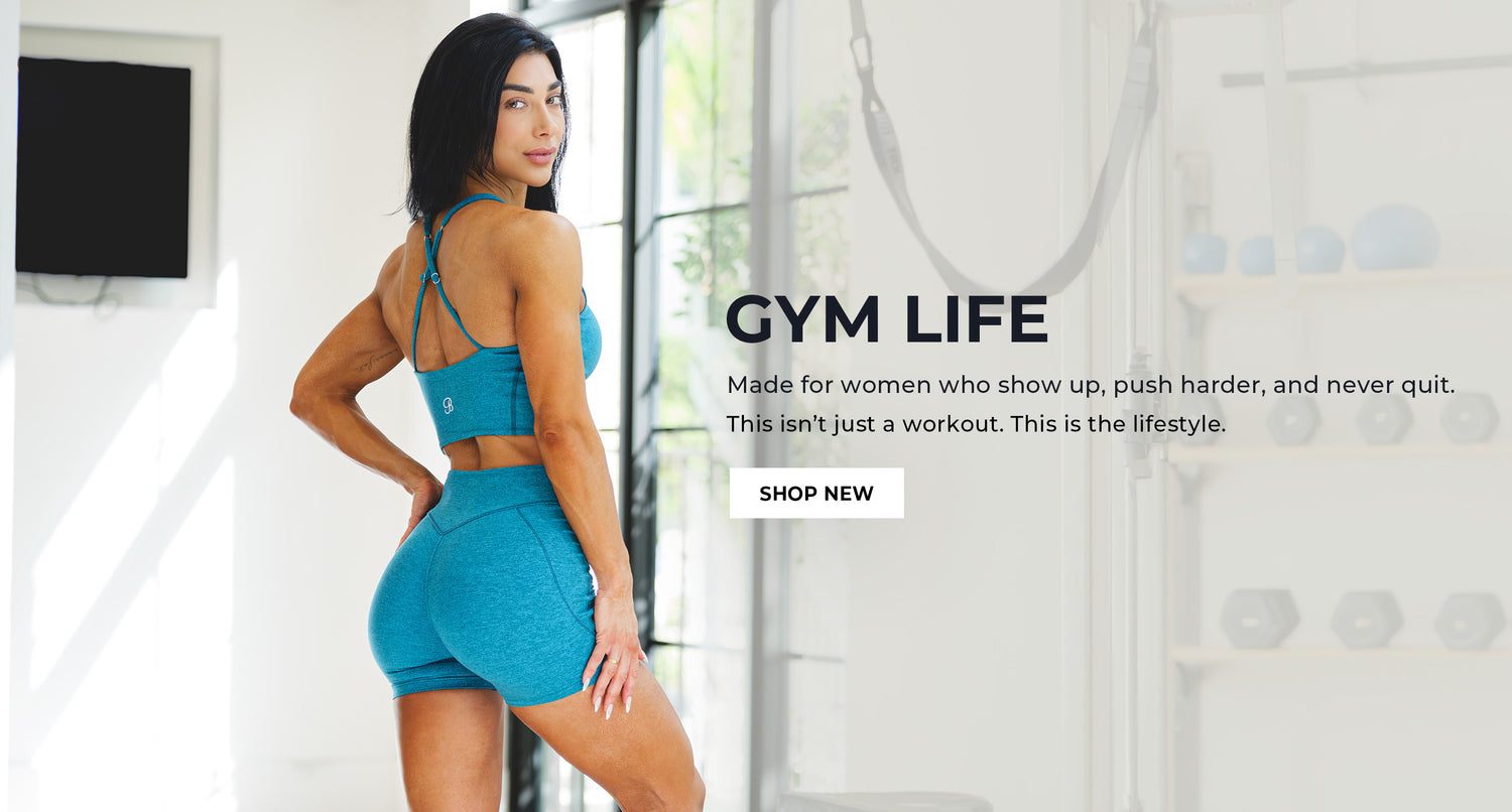 Woman in blue athletic wear standing in a gym setting with promotional text for 'Gym Life'. Text says "GYM LIFE Made for women who show up, push harder, and never quit. This isn't just a workout. This is the lifestyle. SHOP NEW"