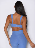 back profile view of a model wearing the Halo Sports Bra in boss blue color