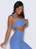 front right side profile view of a model wearing the Halo Sports Bra in boss blue color