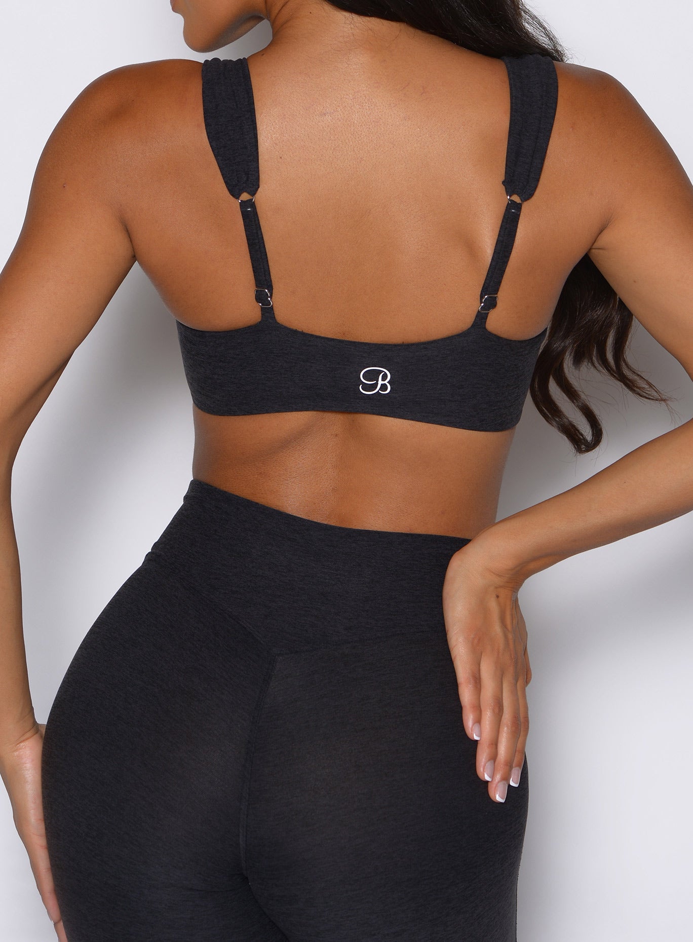 close up back side view of a model wearing the Halo Sports Bra in Heathered Black color