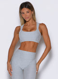 front profile view of a model wearing the Halo Sports Bra in Ice queen color