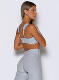 back right side profile view of a model wearing the Halo Sports Bra in Ice queen color