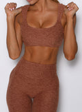 close up front view of a model wearing the Halo Sports Bra in spiced chai color