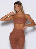 front profile view of a model wearing the Halo Sports Bra in spiced chai color
