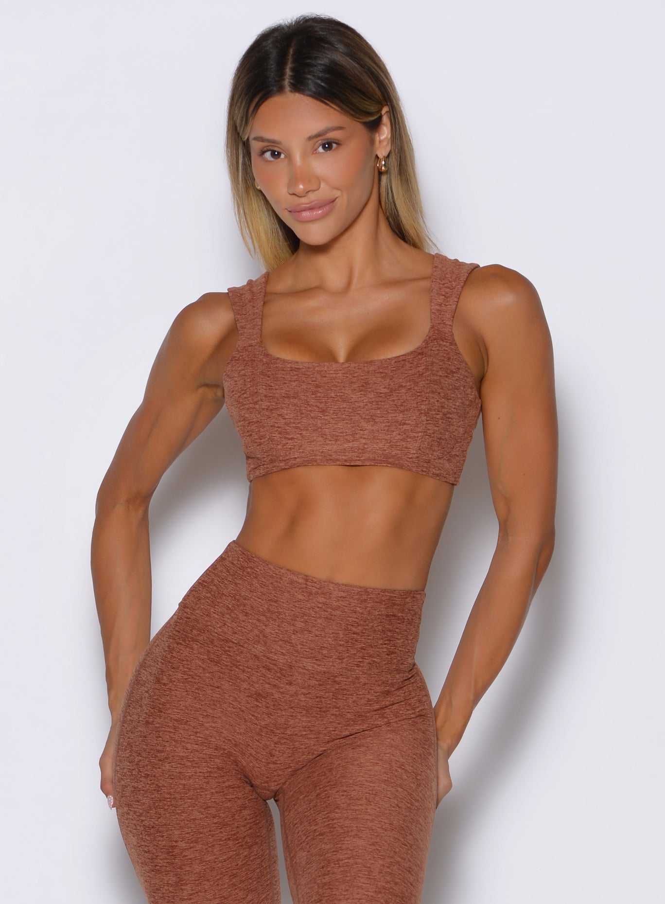 frontal view of a model wearing the halo sports bra in spiced chai color 