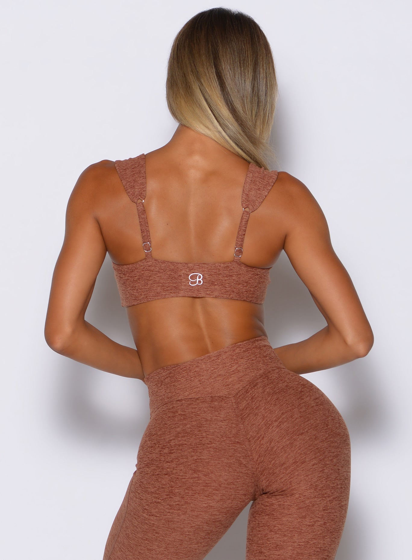 back profile view of a model wearing the Halo Sports Bra in spiced chai color