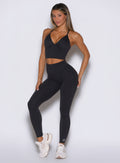 front profile view of a model wearing the Hardbody Leggings in Heathered Black color