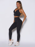 front left side view of a model wearing the Hardbody Leggings in Heathered Black color