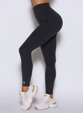 close up left side view of a model wearing the Hardbody Leggings in Heathered Black color