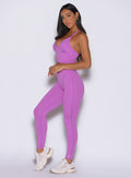 front left side profile view of a model wearing the Hardbody Leggings in Purple Rain color
