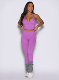 front view of a model looking to the left side wearing the Hardbody Leggings in Purple Rain color