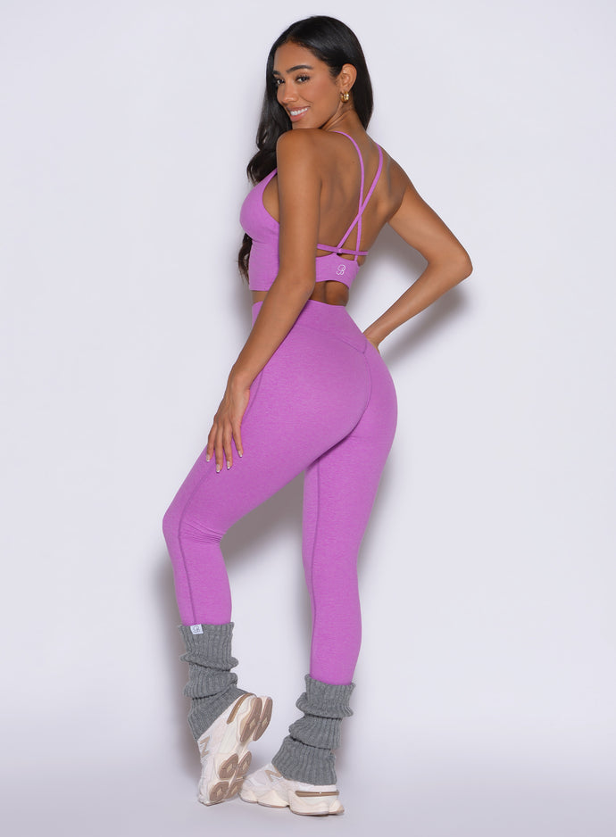 back left side profile view of a model wearing the Hardbody Leggings in Purple Rain color
