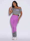 front view of a model wearing the Hardbody Leggings in Purple Rain color paired with the Star Power Tee in core gray color