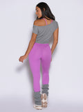 model captured from the back side wearing the Hardbody Leggings in Purple Rain color