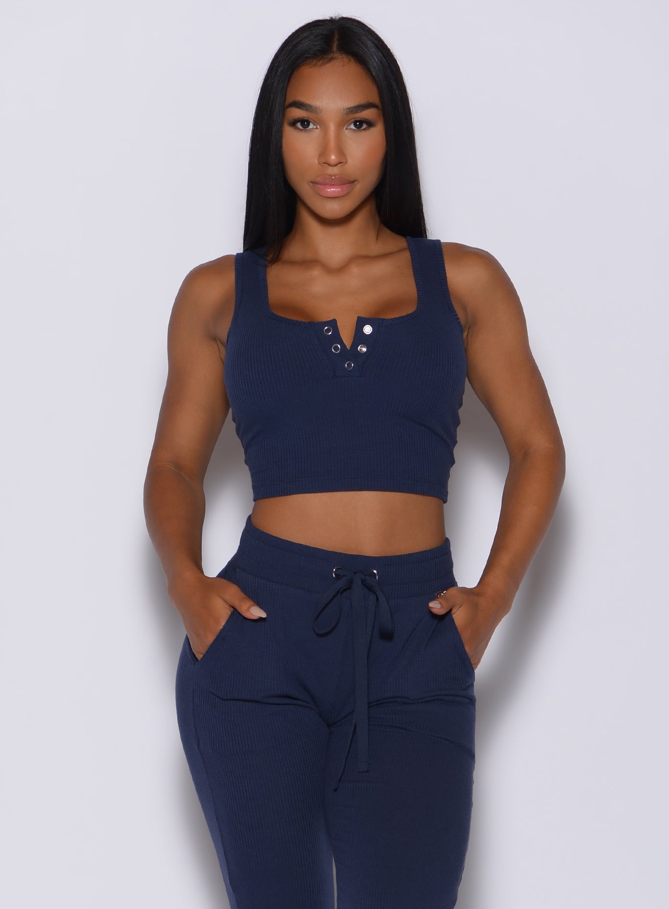 Front  profile view of a model in our henley long bra in navy and a matching joggers
