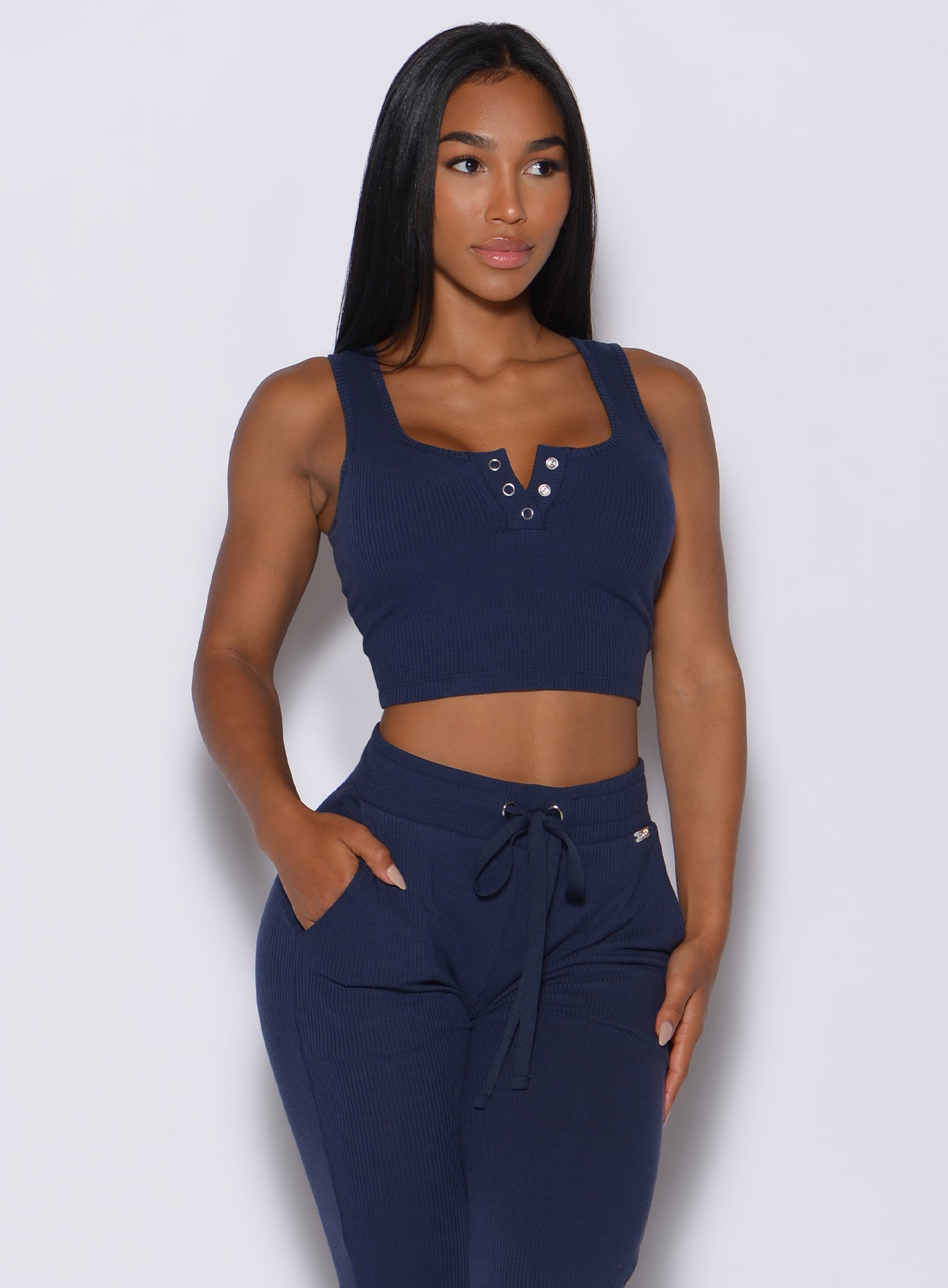 model facing forward wearing our henley long bra in navy along with a matching joggers  