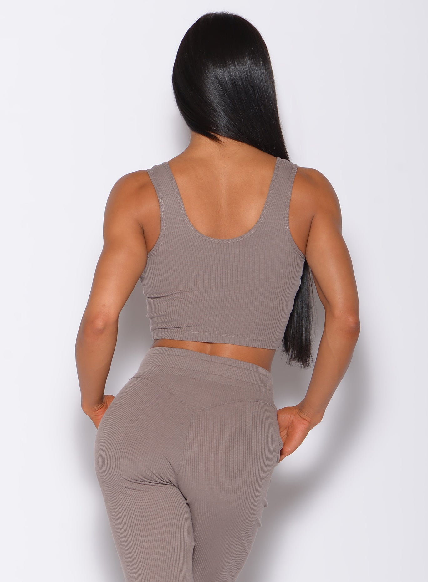 Back profile view of a model wearing our henley long bra in toffee color along with a matching joggers