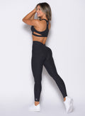 back left side profile view of a model wearing the V Butt Lift Leggings in Heathered Black color