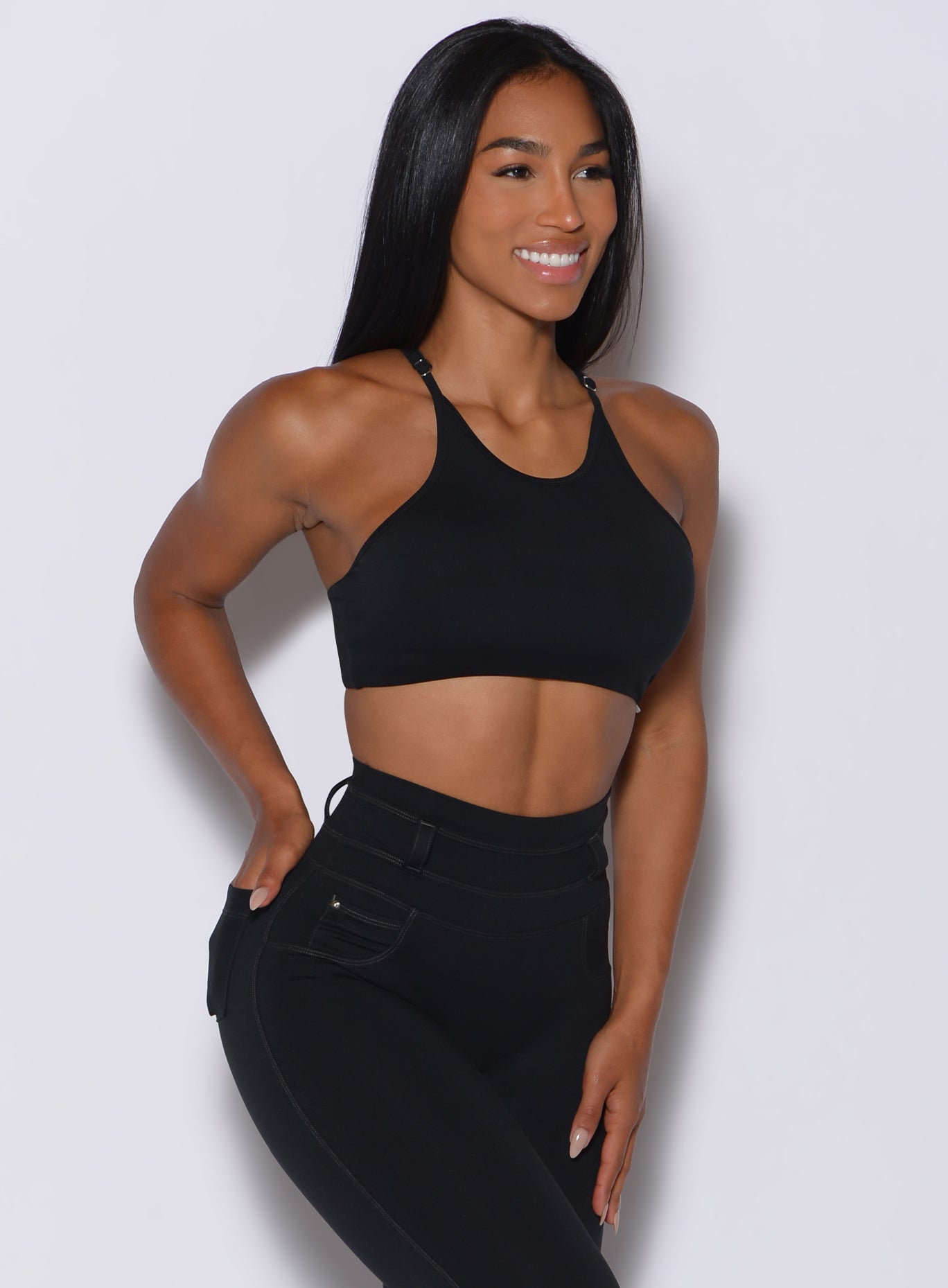 front profile view of a model in our black high neck crop bra and a matching leggings