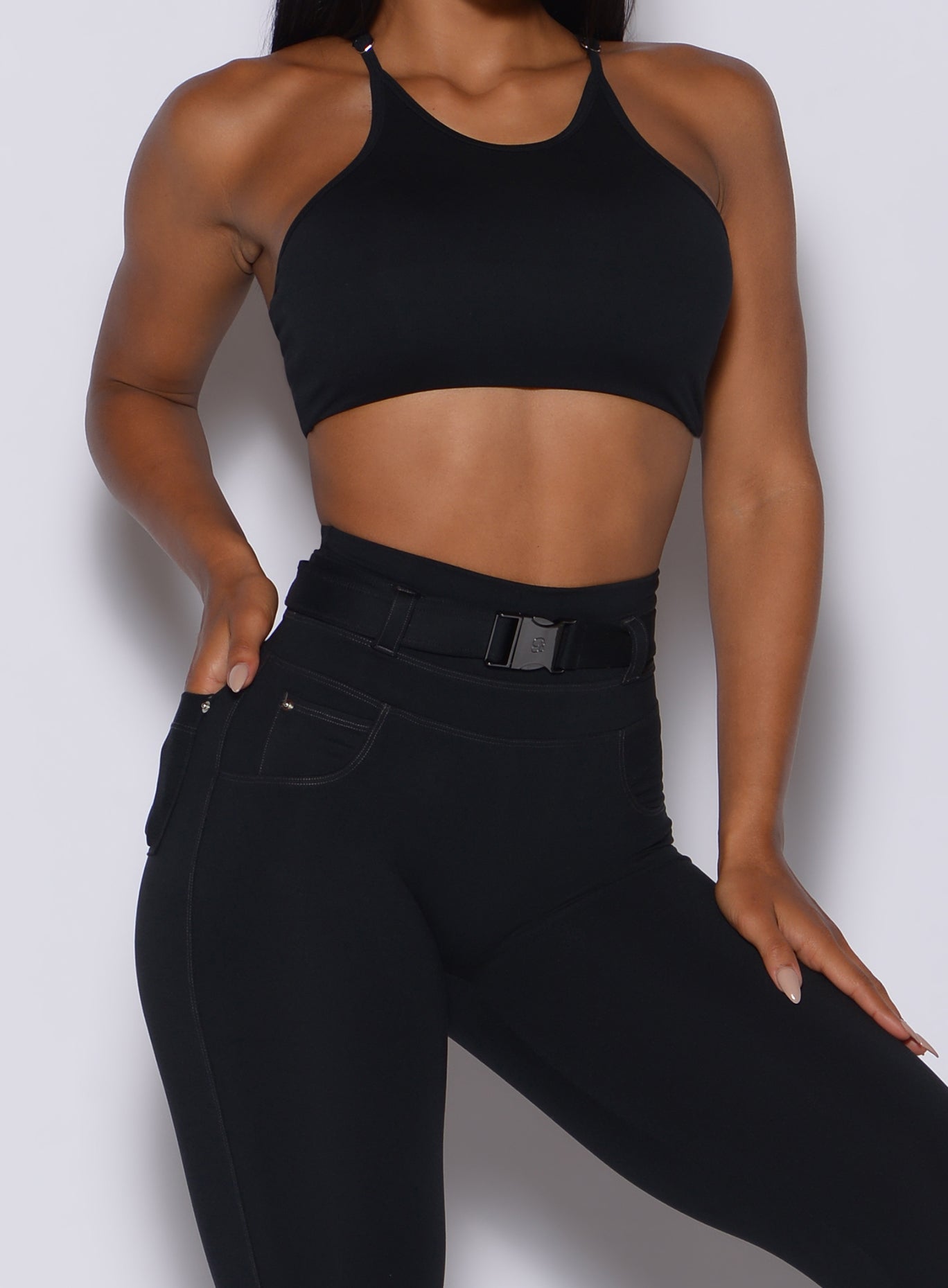 High-neck black crop bra and sculpting Peach Bottoms leggings for a high-intensity gym set.