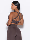 back profile view of model looking her left wearing our High Impact Bra in Seal Brown color and the matching leggings

