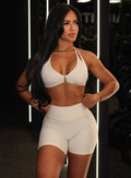 front profile view of a model in indoors wearing the Uplift Peach Shorts in Pearl white color