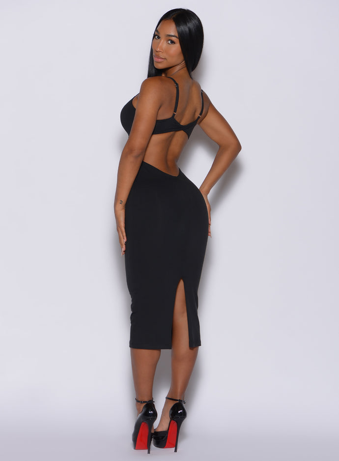 left side profile view of a model facing to her left wearing our black hourglass dress 