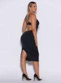 left side  profile view of a model in our black hourglass dress