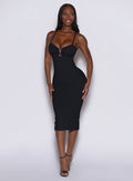 model facing forward with a big smile on her face wearing our black hourglass dress