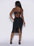 Back profile picture of a model standing and wearing our black hourglass dress 