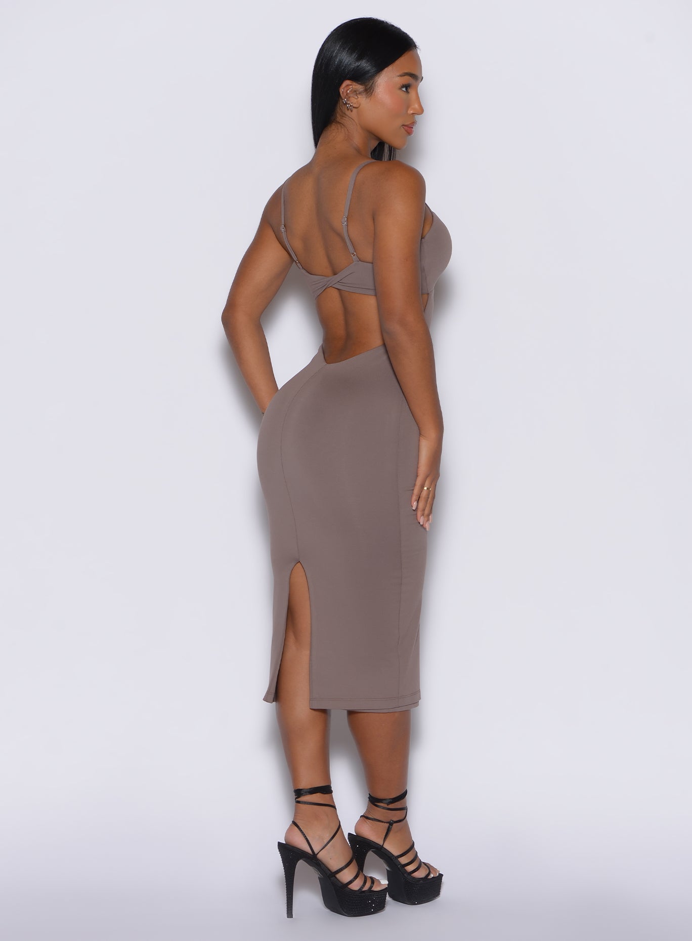 right side profile view of a model facing to her right while wearing our hourglass dress in espresso color 
