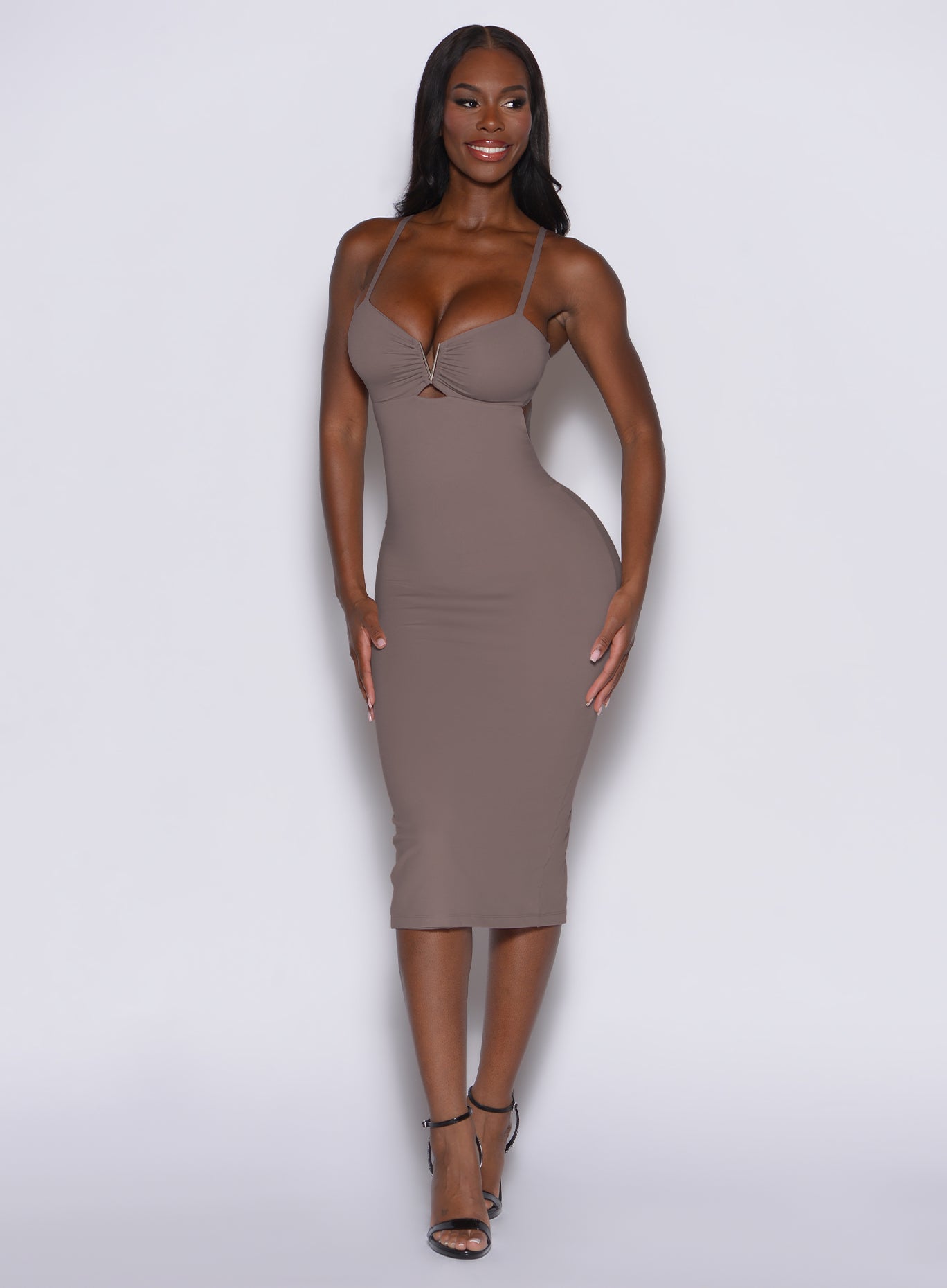 front profile picture of a model looking to her left wearing our hourglass dress in espresso color 