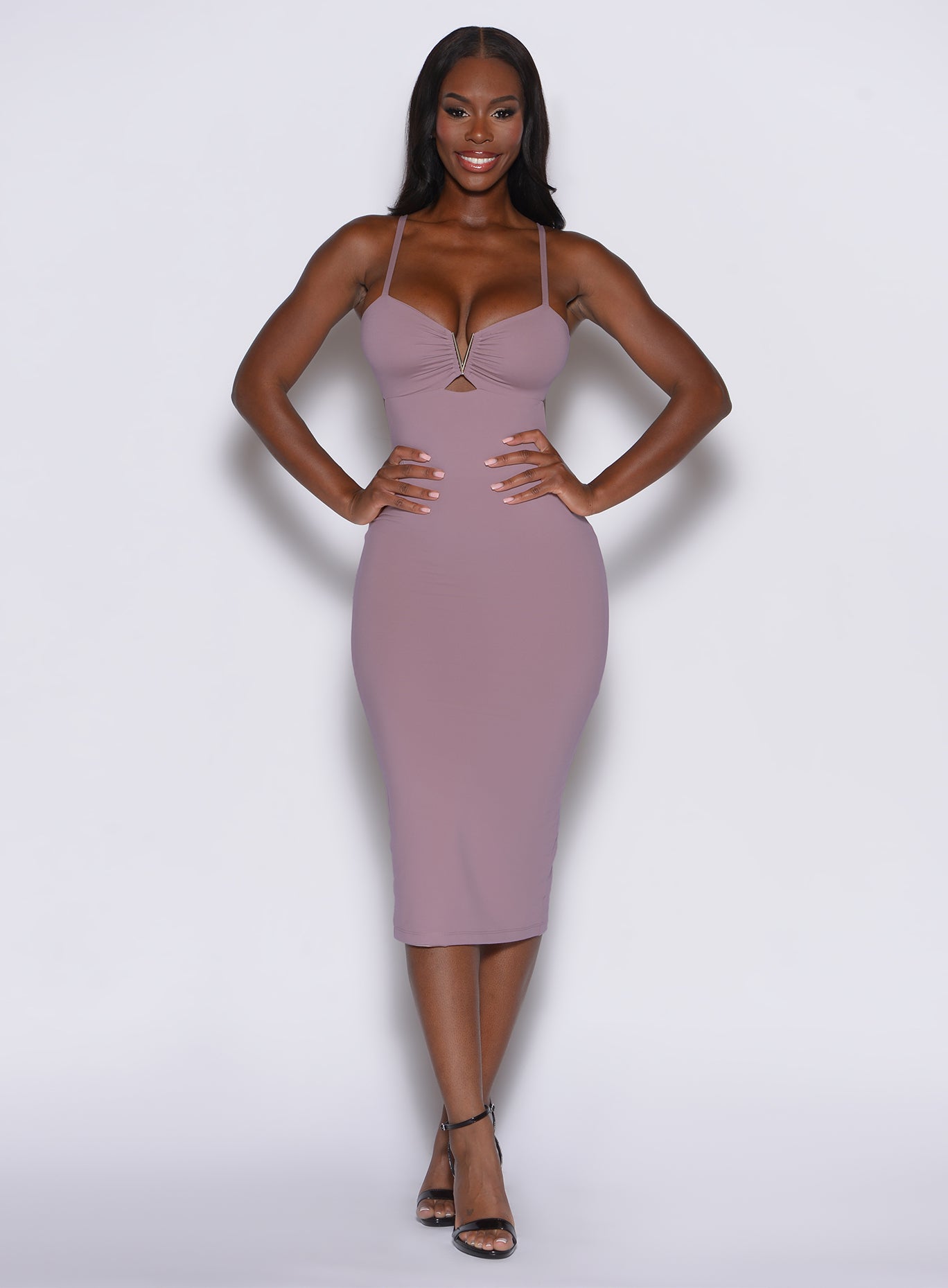 front profile view of a model wearing our hourglass dress in light mauve color