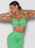 model viewed from the front wearing the Hyper form bra in Neon Miami Beach color