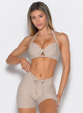 front profile view of a model wearing the Infinity Bandeau in taupe color paired with the matching shorts 