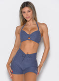 front profile view of a model wearing the Infinity Bandeau in wisteria blue color paired with the matching shorts 