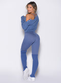 back profile view of a model looking over her shoulder wearing the Internal Scrunch Leggings in blue chill color