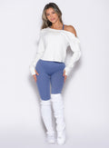 front profile view of a model with both hands on her thighs wearing the Luxe Leg Warmers in white color