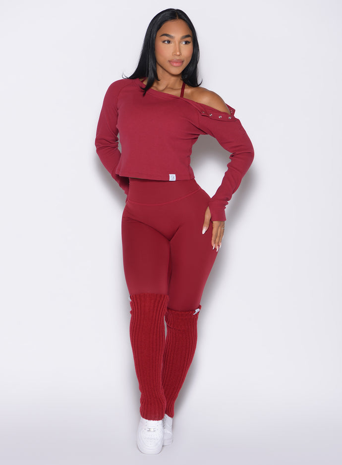 front profile view of a model looking to the left side wearing the Luxe Leg Warmers in red velvet color