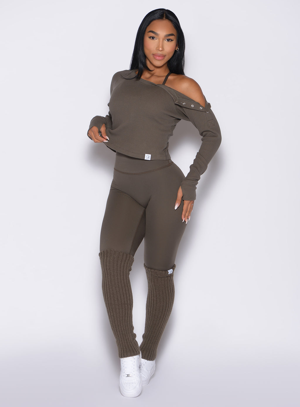 frontal shot of a model wearing the Internal Scrunch Leggings in winter oak paired with the matching top and leg warmers 
