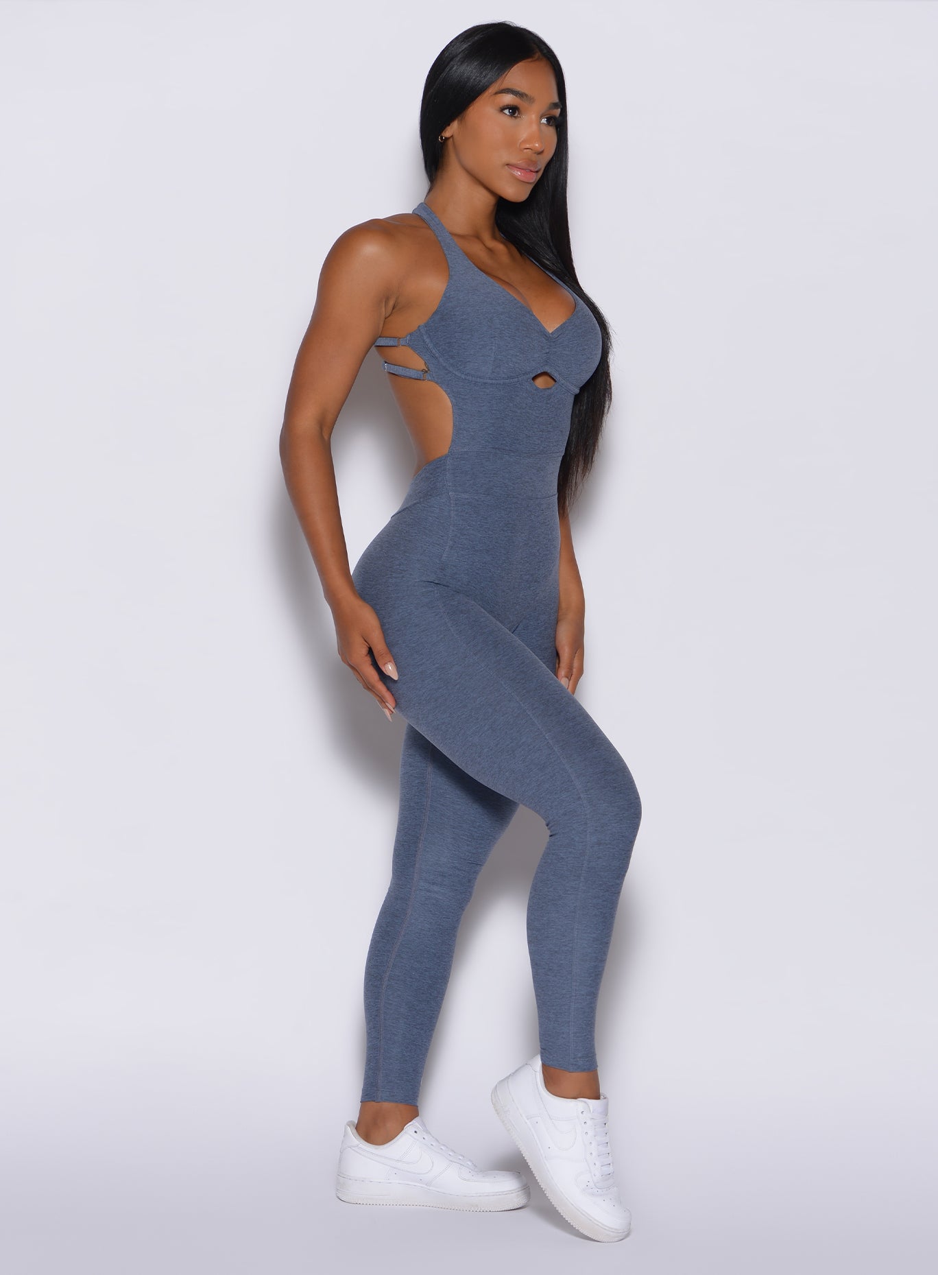 right side  profile view of a model in our full length bombshell bodysuit in twilight color