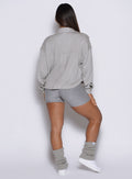back profile view of a model wearing the laidback luxe shirt in dark and stormy color