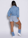 model captured from the back wearing the laidback luxe shirt in Niagara mist color paired with the matching bodysuit shorts 