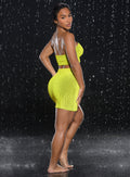 back right side profile view of a model in indoors with water droplets falling around her wearing the Neon Nights Skirt in Lemon Drop color